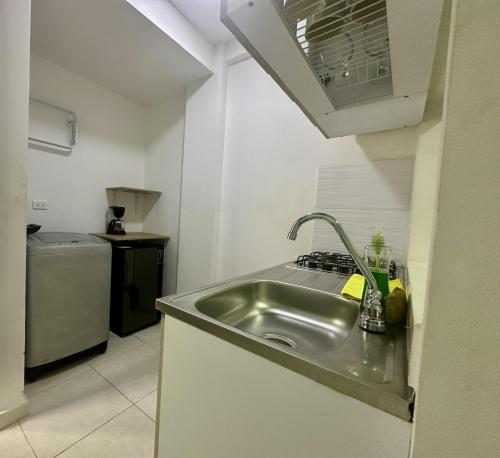 a kitchen with a stainless steel sink and a stove at San Luis Apartamento 301 Cúcuta in Cúcuta