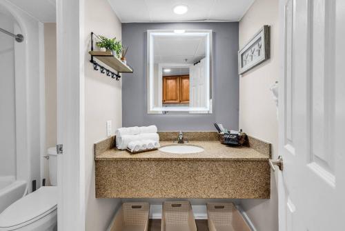 a bathroom with a sink and a toilet at Last Chance Summer, Oceanfront Pools and Beach in Myrtle Beach