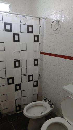 a bathroom with a toilet and a shower at Cabañas Arelí in Santa María