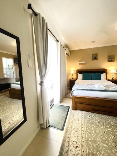 a bedroom with a bed and a large window at 45 Private Guest Suite for 2ACParking in Perth