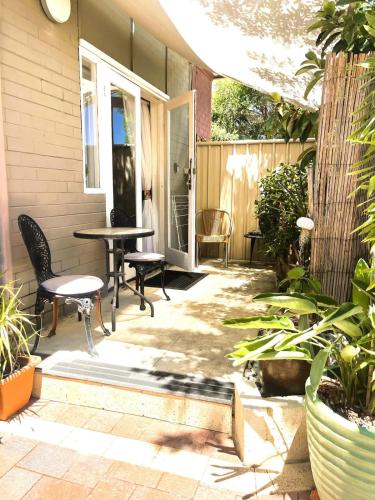 a patio with chairs and a table and some plants at 45 Private Guest Suite for 2ACParking in Perth