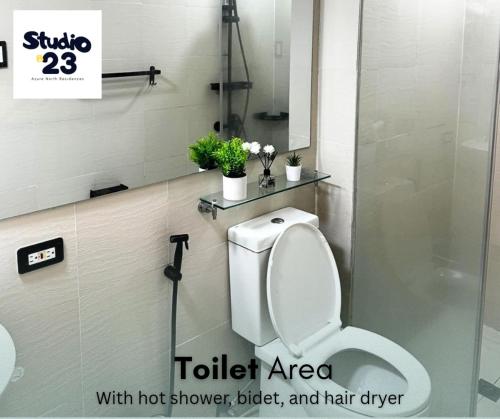 a toilet in a bathroom with a shower and a toilet area at Studio B23 Azure North in San Fernando