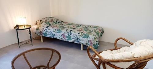 a room with two chairs and a couch and a table at Mas de la clue - 4 personnes in Figanières