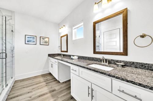 a bathroom with a sink and a mirror at Emerald Escape in Destin, Miramar Beach! 4BR, 4BA, 1st Floor Bedroom, Sleeps up to 14, Golf Cart Included, Pool, Pet Friendly, Private Deeded Beach Access & Gated Community! in Destin