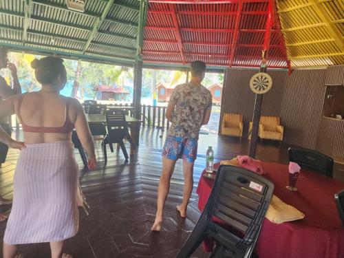 a couple of people standing in a dance floor at Twinbeach Sanctuary in Mersing