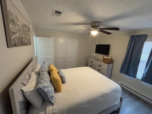 a bedroom with a bed and a ceiling fan at Close-to-Everything Midtown Cottage in Hattiesburg