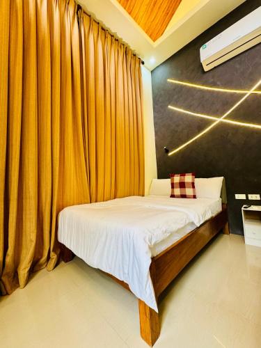 a bedroom with a bed and a curtain at Larue Pocket Villa in Calatagan