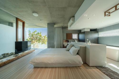 a bedroom with a large bed and a television at Sugar House in Wujie