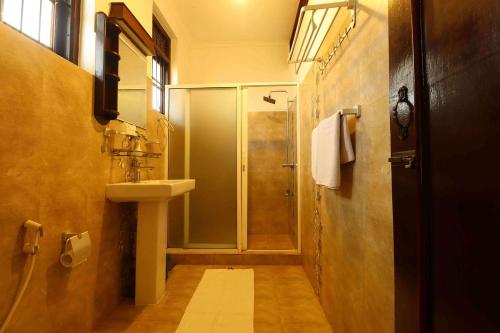 a bathroom with a shower and a sink at Hotel Susantha Garden in Hikkaduwa