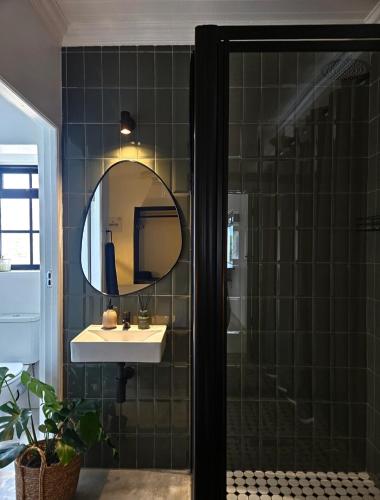 a bathroom with a sink and a mirror at Podium Farm Stay in Swellendam
