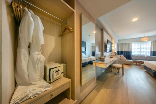 a room with a bedroom and a living room at Jomtien Palm Beach Hotel & Resort - Family-Friendly in Jomtien Beach