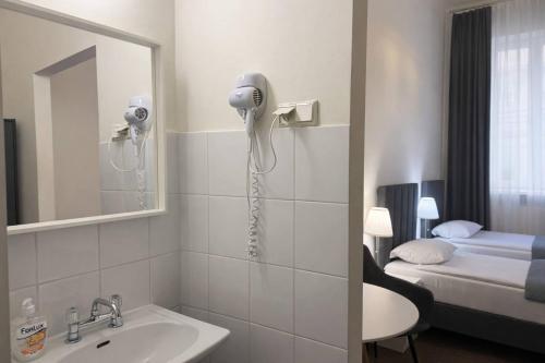 a bathroom with a sink and a blow dryer at Hotel Mazowiecki WOW in Warsaw