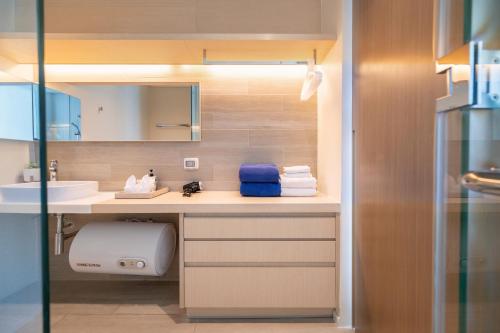 a bathroom with a counter with a sink and a mirror at 2BR Family Condo - Veranda Pattaya - Beachfront in Na Jomtien