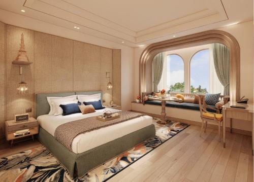 a large bedroom with a large bed and a desk at Taj Ganges Varanasi in Varanasi
