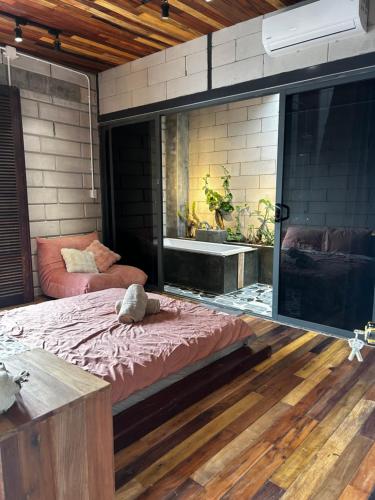 a bedroom with a large bed and a tub at Hong Ly House in Vĩnh Hy