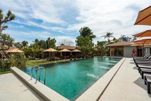 an image of a swimming pool at a resort at Chaykha Retreat Phuket in Chalong