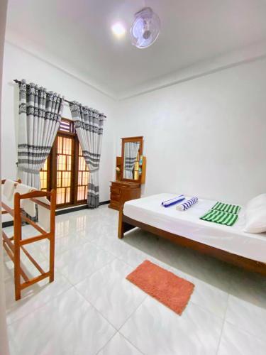 a bedroom with a large bed and a chair at Diyaluma Villa Resort in Koslanda