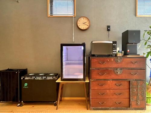 an office with a desk and a clock on the wall at hatago STAY Shinmachi in Nakatsugawa
