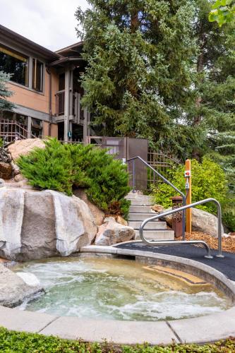 a hot spring in a yard with a house at Aspenwood - CoralTree Residence Collection in Snowmass Village