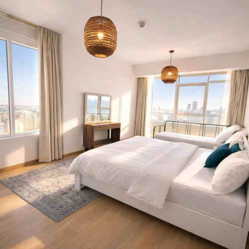 a bedroom with a large white bed and large windows at Resort lifestyle, Fantastic Views, Bright & Brand new in Dubai