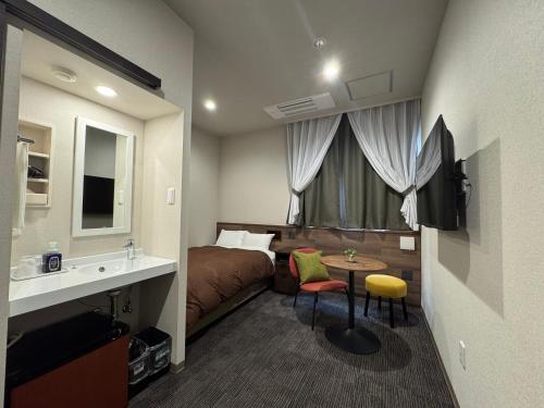 a hotel room with a bed and a sink at Hotel M&M Soma in Soma
