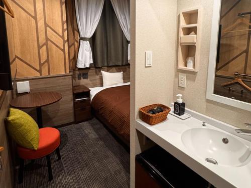 a hotel room with a bed and a sink at Hotel M&M Soma in Soma
