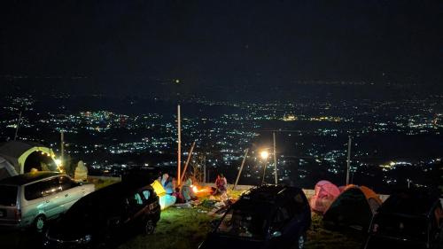 a group of tents on a hill at night at Go Camp in Kemuning
