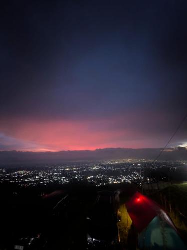 a view of a city at night with a balloon at Go Camp in Kemuning