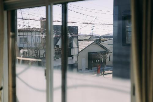 a view from a window of a building at Public Guest House in Karuizawa