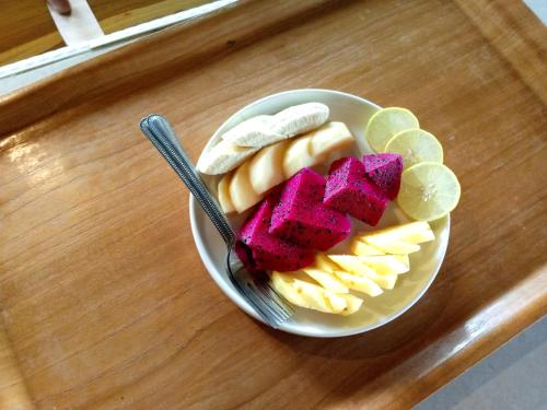 a bowl of fruit and vegetables on a table at Bintang Homestay in Tetebatu