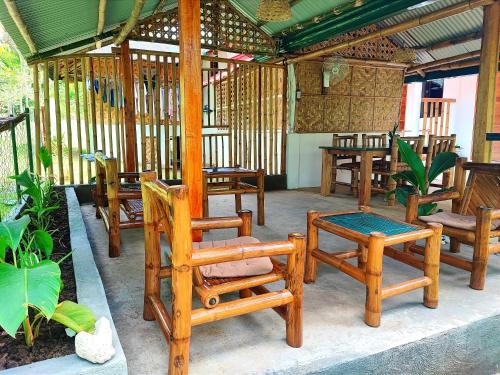 a group of chairs and tables on a patio at Rose Apartments in Anda