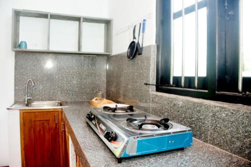 a kitchen with a stove top on a counter at Chenudi Villa Ahangama in Ahangama