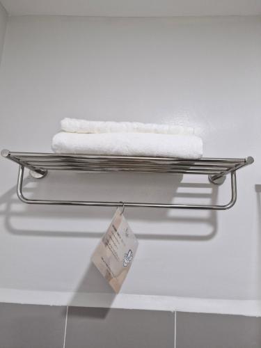 a towel rack in a bathroom with towels on it at WeStay by KM Staycations in Dagupan