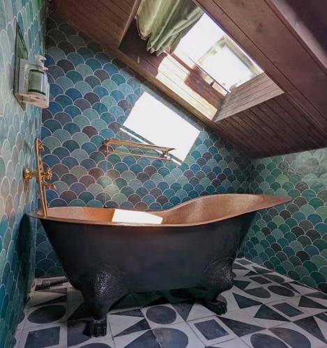 a bath tub in a bathroom with a roof at Impression Nordic Manor Club in Ren'ai