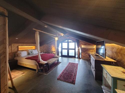 a bedroom with a bed and a television in a room at Impression Nordic Manor Club in Ren'ai