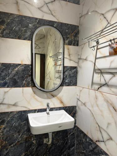 a bathroom with a sink and a mirror at erode kongu mess in Chennai