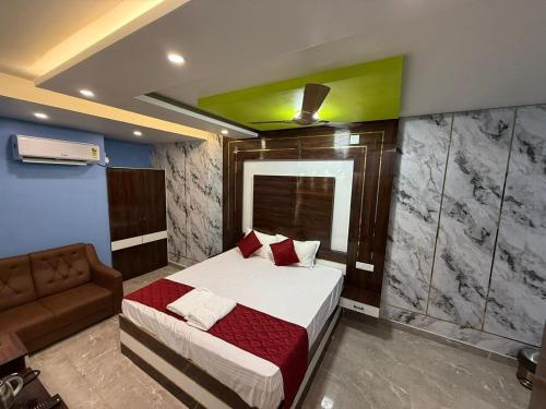 a bedroom with a bed and a couch at erode kongu mess in Chennai