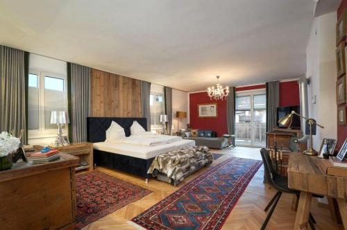 a bedroom with a bed and a desk in a room at MountainRelaxKtzh in Kitzbühel
