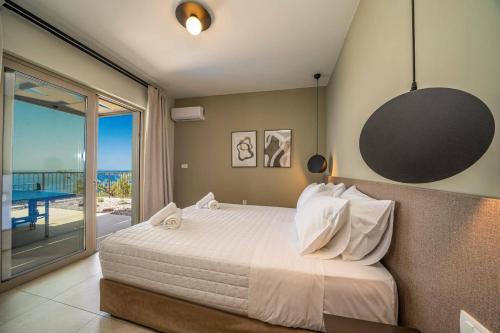 a bedroom with a bed with a view of the ocean at Villa Katoikia Dio by Villa Plus in Simotáta