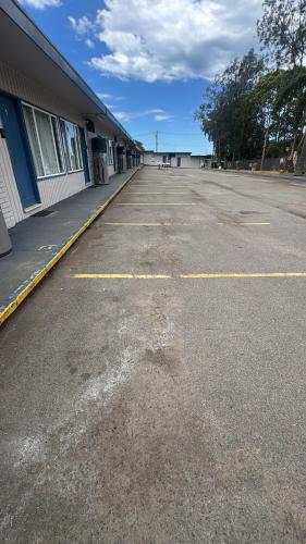 an empty parking lot in front of a building at Mayfield Motel in Mayfield
