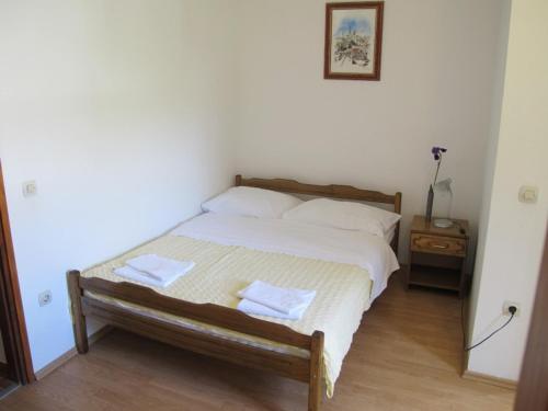 a bedroom with a bed with two towels on it at Apartments and Rooms Degenija in Starigrad-Paklenica