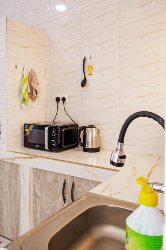 a kitchen with a sink and a toaster on a counter at Azara Watamu in Watamu