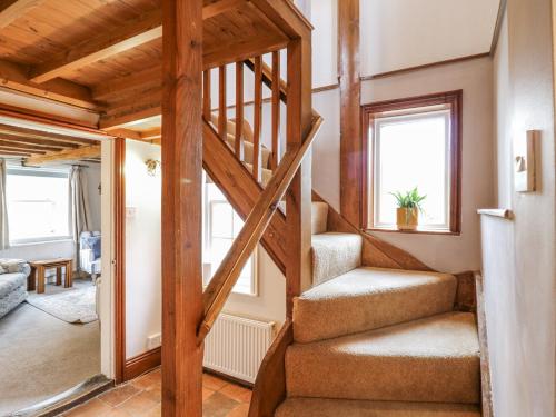 a staircase in a house with a living room at White Gates in Norwich