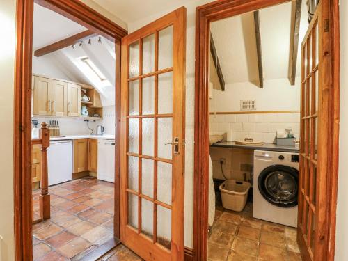 a kitchen with a washer and a washing machine at White Gates in Norwich