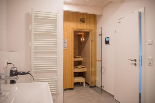 a bathroom with a sink and a toilet and a closet at Gulfhof Wangermeer 1 Lotta in Hohenkirchen