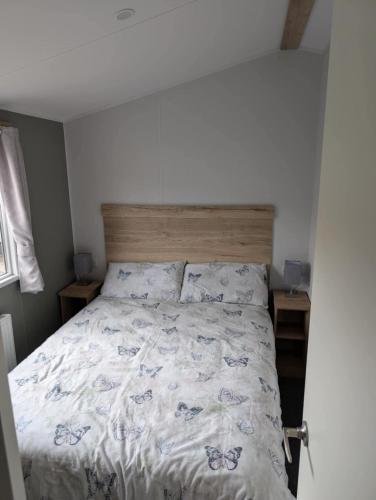 a bedroom with a large bed with a wooden headboard at T&K's Caravan in Morecambe