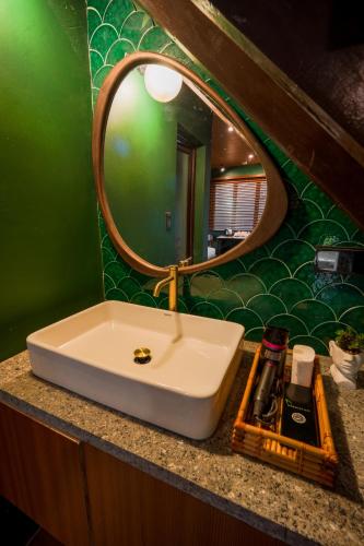 a bathroom with a white sink and a mirror at Aran Villas in Santa Maria