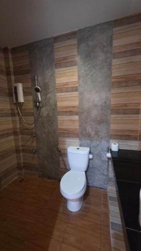 a bathroom with a toilet and a shower at Myhomevillage in Ko Tao