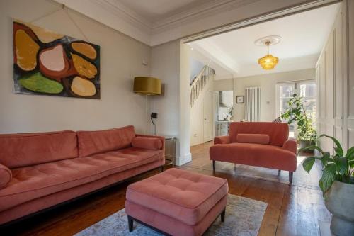 a living room with a couch and two chairs at Sycamore House in York