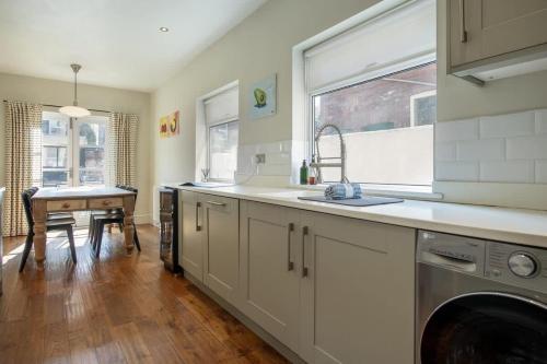 a kitchen with a sink and a washing machine at Sycamore House in York